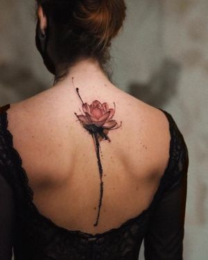 Intricately designed illustrative blackwork tattoo of a flower on the back, expertly executed by the talented artists at La Bottega dell'Arte.