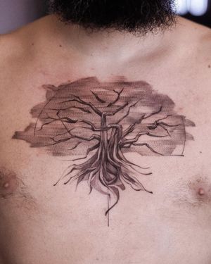 Explore the intricate beauty of nature with this striking blackwork tree design by Osman Ergin. Perfect for a bold and timeless chest piece.