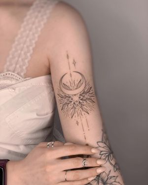 A stunning fine line and geometric mandala tattoo featuring a moon motif, created by the talented artist Nika Shvets. Perfect for the upper arm placement.
