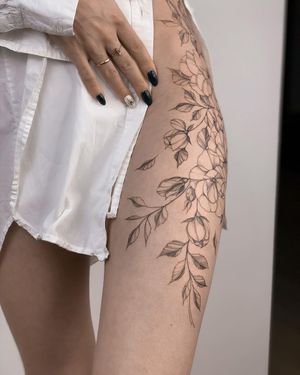 Beautiful flower design on upper leg by talented artist Nika Shvets. A unique piece of art that will stand out.