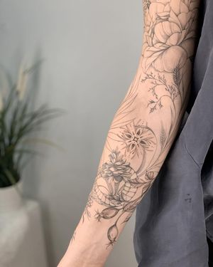 Experience Nika Shvets' intricate blackwork design combining a snake, flower, and pattern mandala on your sleeve.