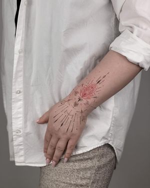 Illustrative tattoo by Nika Shvets featuring intricate hamsa design and delicate fine line work on the forearm.