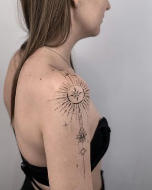 Elegant fine line design by Nika Shvets featuring moon, flower, lotus, and intricate patterns on the upper arm.