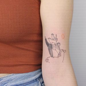 Beautiful and intricate upper arm tattoo featuring a fine line illustration of a sun, horse, and cat by Tuğçe özbıyık.