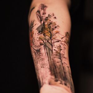 Illustrative tattoo featuring a tree and pattern design on the forearm by La Bottega dell'Arte.