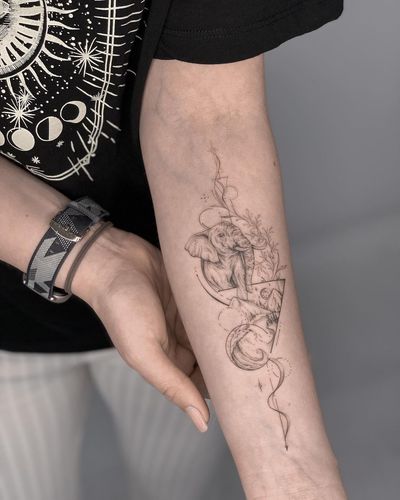 Geometric and illustrative forearm tattoo featuring a mountain, elephant, and triangle motif, created by Nika Shvets.