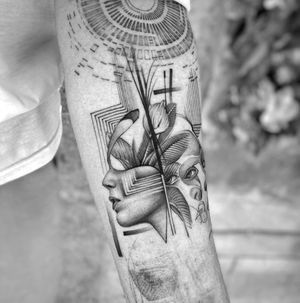 Fine line blackwork forearm tattoo by Murat Yılmaz featuring a geometric design of a woman, muscles, and leaves.