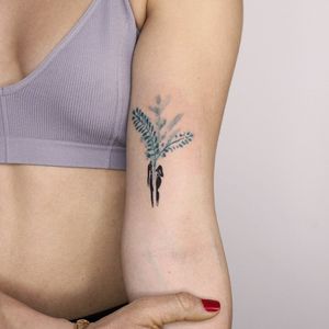 Beautiful upper arm tattoo of a delicate flower sprig done in fine line illustrative style by Tuğçe özbıyık.