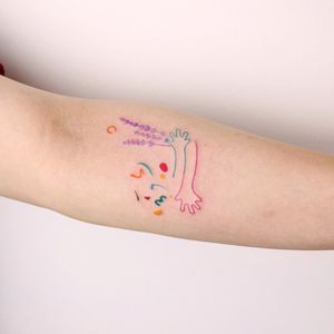 Exquisite forearm tattoo featuring a delicate flower pattern and a hand sprig by Tuğçe özbıyık.