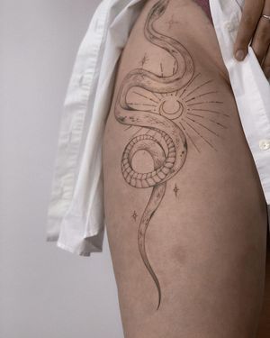 Experience the mystical beauty of a fine line blackwork moon and snake tattoo by the talented artist Nika Shvets.