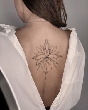 Elegant blackwork and fine line tattoo featuring a stunning floral mandala design by the talented artist Nika Shvets.