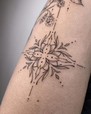 Adorn your arm with this stunning blackwork, fine line tattoo by the talented Nika Shvets, featuring a intricate geometric mandala pattern.