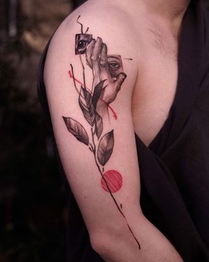 Unique blackwork tattoo by Osman Ergin featuring a woman's hand with a beautiful flower pattern on the upper arm.