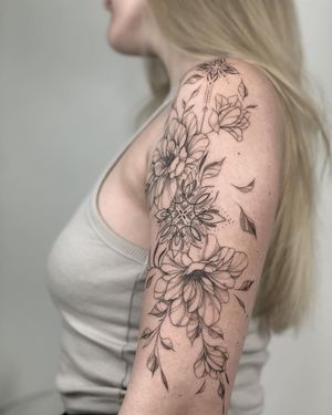 Elegantly detailed blackwork peony mandala tattoo by Nika Shvets on upper arm. Delicate and intricate design.