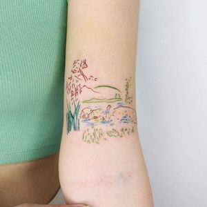 A stunning upper arm tattoo by Tuğçe özbıyık featuring delicate fine line illustrations of water, flowers, patterns, and a woman.