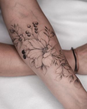 Beautiful blackwork flower tattoo on forearm by tattoo artist Adrian Mokijewski. Detailed and artistic design.