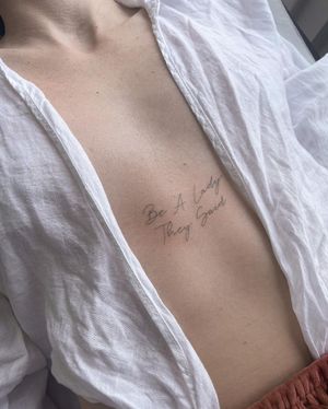 Exquisite chest tattoo featuring small lettering and illustrative design by Dominika Gajewska.