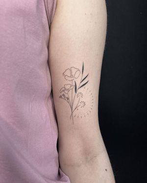 Beautiful illustrative flower tattoo on upper arm, by Dominika Gajewska. Delicate and intricate design.