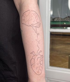 Illustrative tattoo by Dominika Gajewska featuring a unique design combining a heart, intricate pattern, and brain on the forearm.