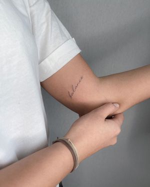 Get inspired with this fine line illustrative tattoo on your upper arm. Small lettering with a powerful message.
