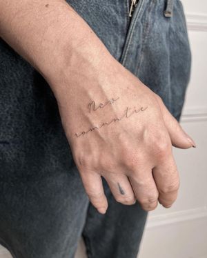 A small illustrative tattoo featuring a quote in delicate lettering, expertly done by Dominika Gajewska.