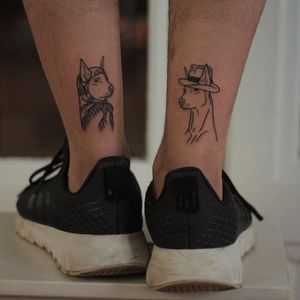 This illustrative tattoo by Kaśka features a finely detailed blackwork design of a dog wearing a hat, perfect for the lower leg.