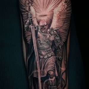 Impressive black and gray forearm tattoo featuring a warrior with armor, sword, and wings in realistic style. Located in Chicago, US.