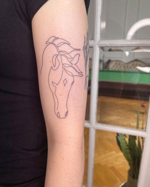 Elegant and detailed fine line horse tattoo on the upper arm, beautifully designed by Dominika Gajewska.