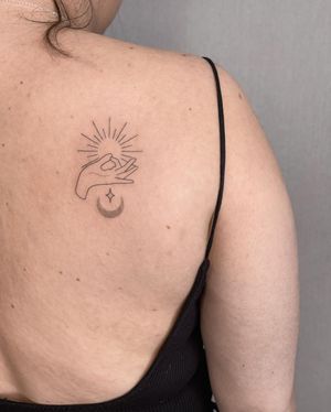 Elegant upper back tattoo by Dominika Gajewska featuring intricate geometric patterns and hand motifs.