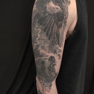 Experience the powerful combination of a bear, eagle, and lake in this realistic and illustrative design on your upper arm in Chicago.