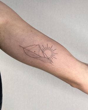 A stunning fine line illustrative tattoo on the forearm featuring a sun, mountain, and waves, by Dominika Gajewska.