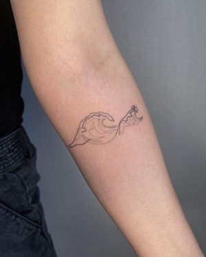 Illustrative waves tattoo on forearm by Dominika Gajewska. Dive into the beauty of the ocean with this delicate design.