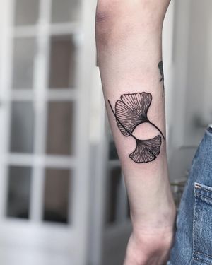 Beautiful blackwork flower design by tattoo artist Kaśka, perfect for forearm placement.