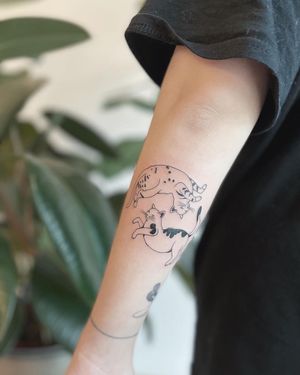 Get a gorgeous illustrative cat tattoo on your upper arm by the talented artist Kaśka. This fine line design will make a sophisticated statement.
