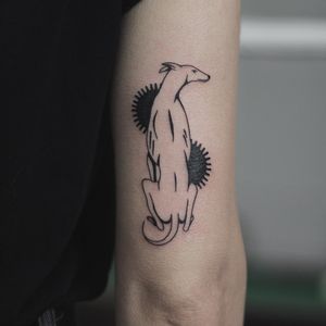 Adorn your upper arm with a stunning blackwork dog tattoo by the talented artist Kaśka. Embrace the beauty of illustrative art in this unique design.
