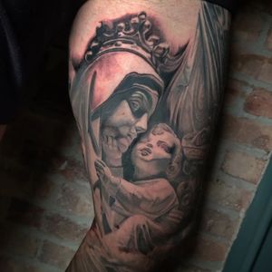 Get a stunning black and gray realism tattoo of an angel with a crown on your arm in Chicago.