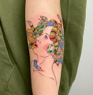 Get mesmerized by this stunning forearm tattoo featuring a captivating snake and mythical medusa, expertly done by Magdalena Sawicka.