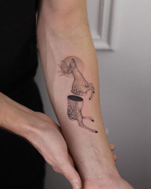 Elegant black and gray forearm tattoo of a majestic deer with intricate horns, expertly done by Adrian Mokijewski.