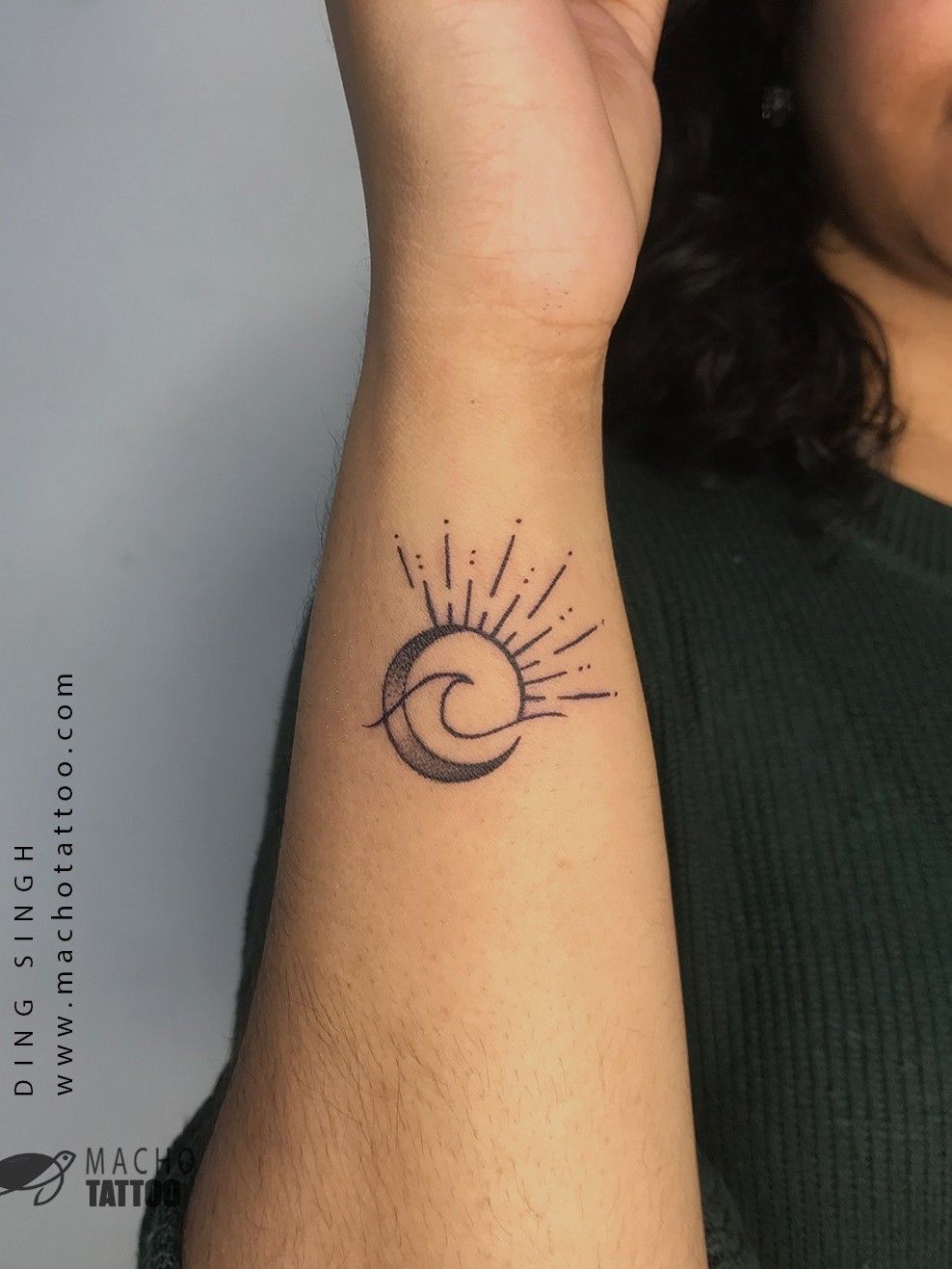 Minimalist crescent moon tattoo on the wrist