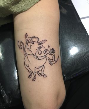 A unique illustrative tattoo on the upper arm featuring iconic characters from The Lion King. By artist Natalie Lucia.