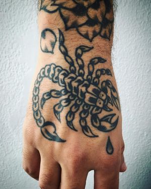 Experience the striking beauty of Phil Botha's blackwork scorpion design on your hand. Bold and dramatic, this piece will stand out in any crowd.