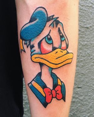 Classic illustrated tattoo of Donald Duck wearing his signature hat, done by Phil Botha in traditional style.