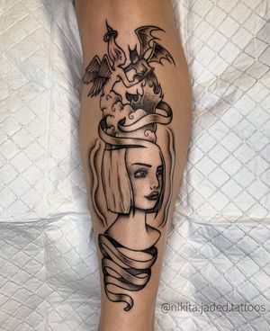 Blackwork illustrative tattoo by Nikita Jade Morgan featuring a devil and angel girl motif on the forearm.