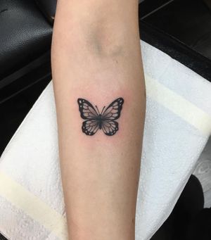 Natalie Lucia creates a stunning blackwork butterfly design on your forearm, blending beauty with edgy style.