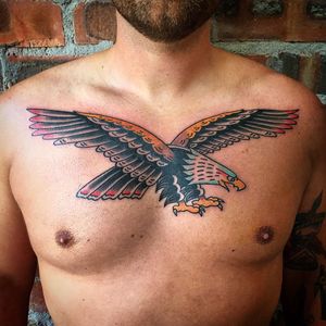 Capture the power and freedom of the eagle with this bold traditional chest piece by Phil Botha.