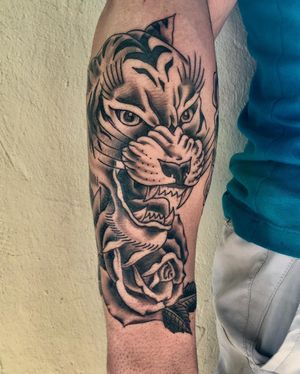 Capture the beauty of nature with this bold blackwork tiger and intricate floral design by Phil Botha.
