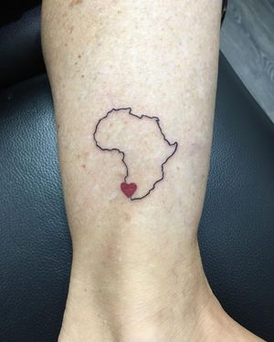Beautiful ankle tattoo featuring a delicate heart intertwined with a map, done by the talented artist Natalie Lucia.