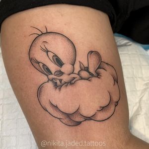 Get a stunning blackwork illustrative design of Tweety bird and clouds by the talented artist Nikita Jade Morgan on your upper arm.