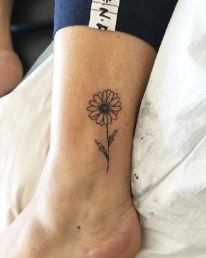 Elegant fine line illustrative flower tattoo by Natalie Lucia, perfect for ankle placement.