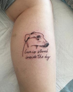 Beautiful blackwork illustration of a dog with small lettering quote on lower leg by talented artist Natalie Lucia.